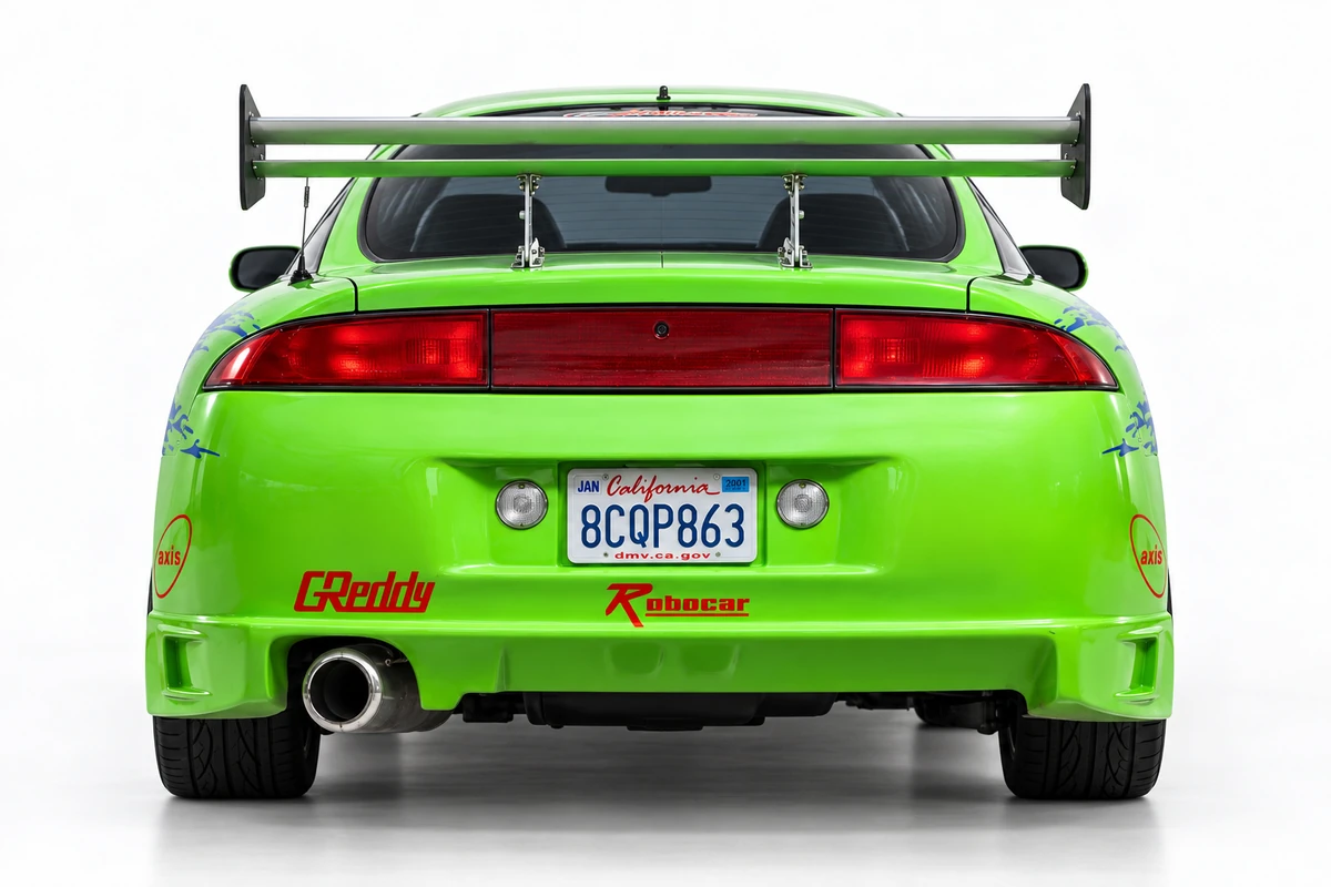 Rear studio shot showing the full-width red light bar, single exhaust tip, and rear wing.