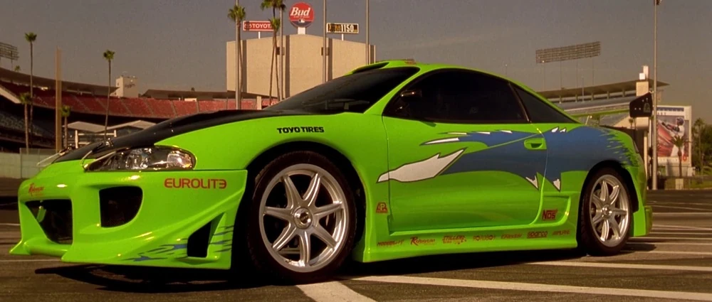 Full size side profile shot of the real-world 1995 Mitsubishi Eclipse with blue graphics and alloy wheels.