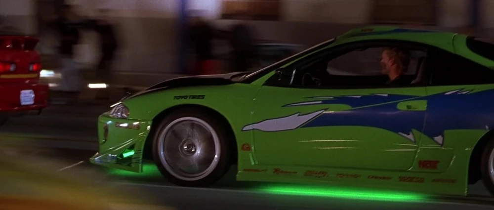 Movie action shot of Brian driving the lime green Mitsubishi Eclipse at speed.